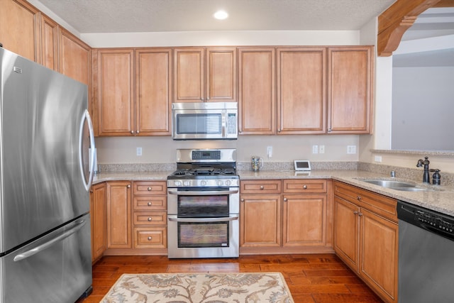 6615 Mountain Hawk Loop NE, Rio Rancho, NM 87144 - kitchen featuring stainless steel appliances, dark wood-type flooring, light stone countertops, and recessed lighting