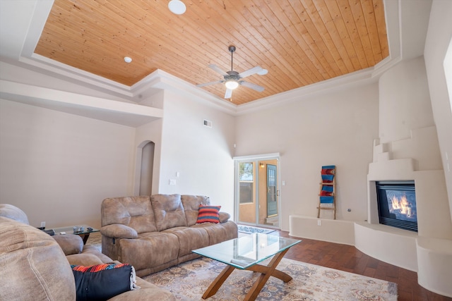 6615 Mountain Hawk Loop NE, Rio Rancho, NM 87144 - living area with wood ceiling, crown molding, hardwood / wood-style floors, arched walkways, and a large fireplace