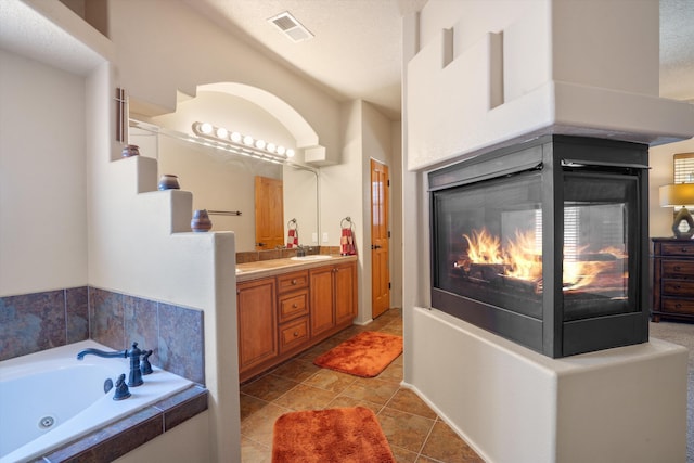 6615 Mountain Hawk Loop NE, Rio Rancho, NM 87144 - bathroom with vanity, a whirlpool tub, and a multi sided fireplace