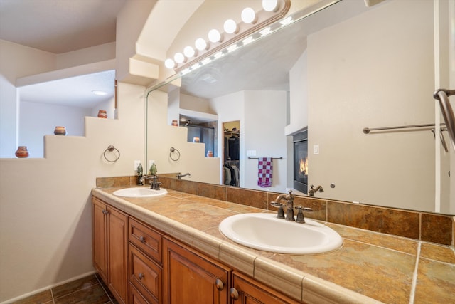 6615 Mountain Hawk Loop NE, Rio Rancho, NM 87144 - bathroom featuring double vanity, a spacious closet, and tile patterned flooring