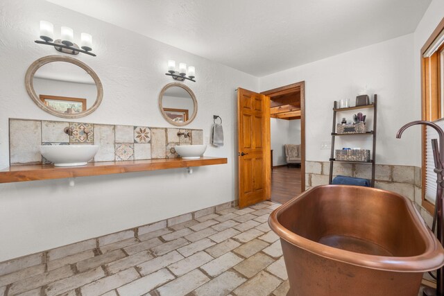 1524 W Meadowlark Ln, Corrales, NM 87048 - full bathroom with a soaking tub, double vanity, and tasteful backsplash
