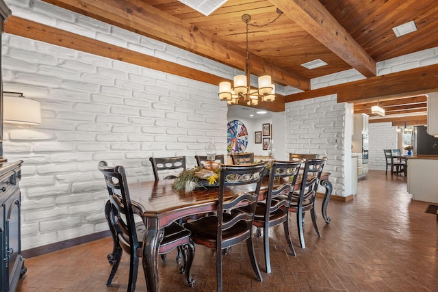 1524 W Meadowlark Ln, Corrales, NM 87048 - dining space with a wooden ceiling with exposed beams, brick floors, a chandelier, and brick wall