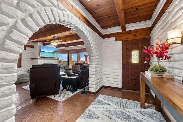 1524 W Meadowlark Ln, Corrales, NM 87048 - foyer with a wooden ceiling with exposed beams, ceiling fan, brick floors, a fireplace, and arched walkways