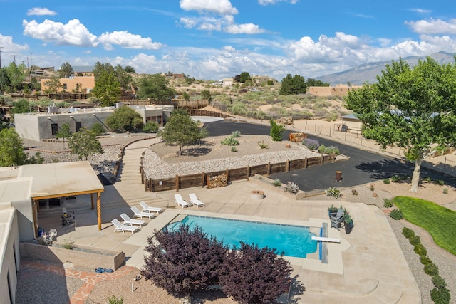 1524 W Meadowlark Ln, Corrales, NM 87048 - outdoor pool with a patio area, a diving board, and a mountain view