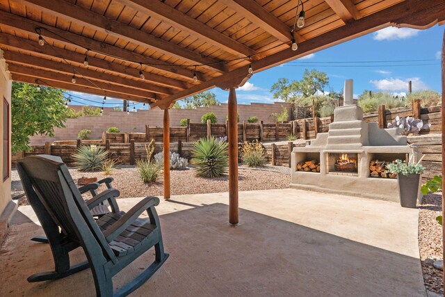 1524 W Meadowlark Ln, Corrales, NM 87048 - view of patio with a warm lit fireplace