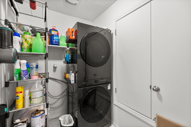 9909 Saddlehorn Trl SW, Albuquerque, NM 87121 - washroom with stacked washer and clothes dryer and a textured ceiling