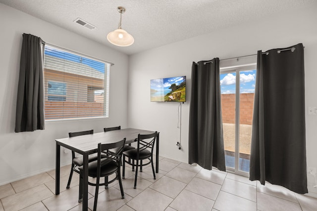 9909 Saddlehorn Trl SW, Albuquerque, NM 87121 - dining area featuring a textured ceiling and light tile patterned floors