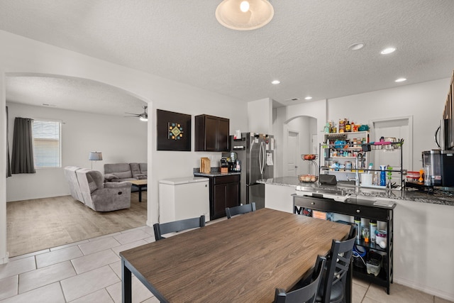 9909 Saddlehorn Trl SW, Albuquerque, NM 87121 - dining area featuring arched walkways, light tile patterned flooring, a ceiling fan, a textured ceiling, and recessed lighting
