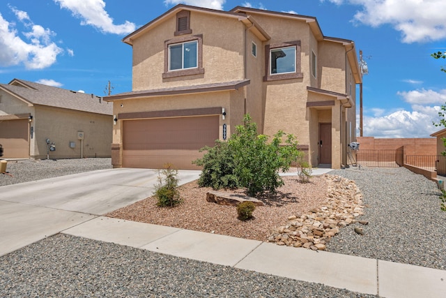 9909 Saddlehorn Trl SW, Albuquerque, NM 87121 - view of front of house with stucco siding, driveway, and an attached garage