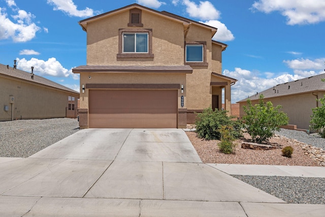 9909 Saddlehorn Trl SW, Albuquerque, NM 87121 - view of front facade with an attached garage, stucco siding, and concrete driveway