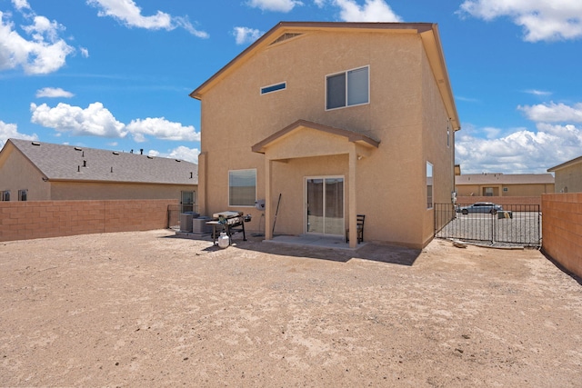 9909 Saddlehorn Trl SW, Albuquerque, NM 87121 - rear view of house featuring stucco siding, a fenced backyard, and a patio