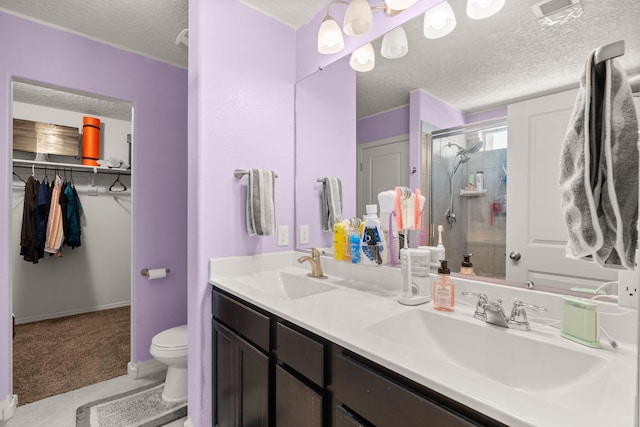 9909 Saddlehorn Trl SW, Albuquerque, NM 87121 - full bath featuring a textured ceiling, a stall shower, double vanity, tile patterned flooring, and a spacious closet