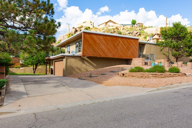 13527 Cedarbrook Ave NE, Albuquerque, NM 87111 - mid-century modern home featuring concrete driveway, stucco siding, and an attached garage