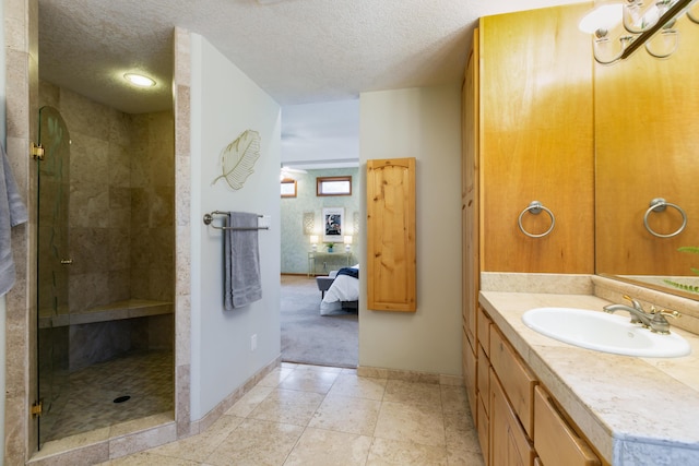 13527 Cedarbrook Ave NE, Albuquerque, NM 87111 - ensuite bathroom featuring vanity, a shower stall, and a textured ceiling