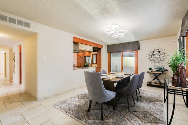 13527 Cedarbrook Ave NE, Albuquerque, NM 87111 - dining space with a chandelier, light tile patterned floors, and a textured ceiling