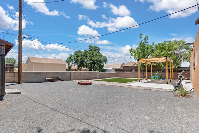 11608 Clifford Ave NE, Albuquerque, NM 87112 - fenced backyard with an outdoor fire pit, a patio area, and a pergola