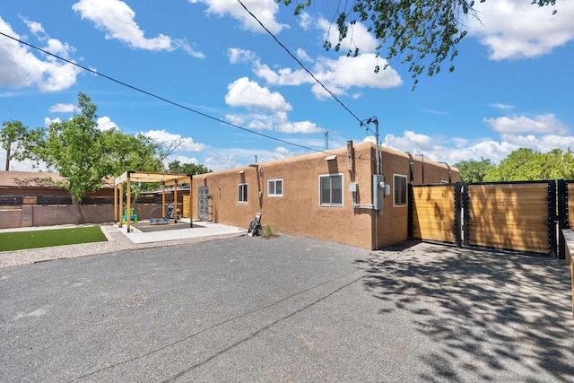 11608 Clifford Ave NE, Albuquerque, NM 87112 - back of property featuring stucco siding, a patio, and a gate