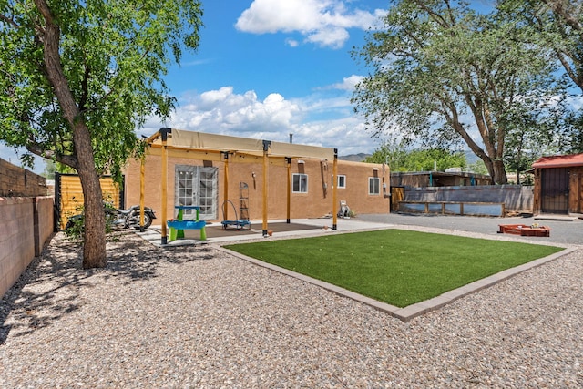 11608 Clifford Ave NE, Albuquerque, NM 87112 - back of house with an outdoor fire pit, stucco siding, a patio area, and a fenced backyard