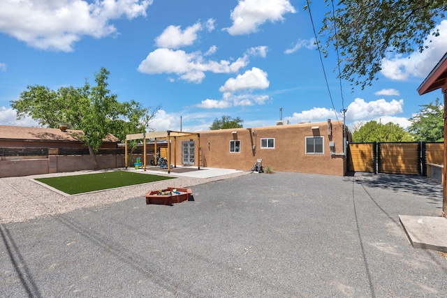 11608 Clifford Ave NE, Albuquerque, NM 87112 - rear view of property featuring a patio, stucco siding, and a gate