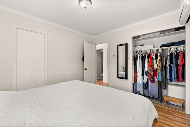 11608 Clifford Ave NE, Albuquerque, NM 87112 - bedroom with an AC wall unit, wood finished floors, a closet, and crown molding