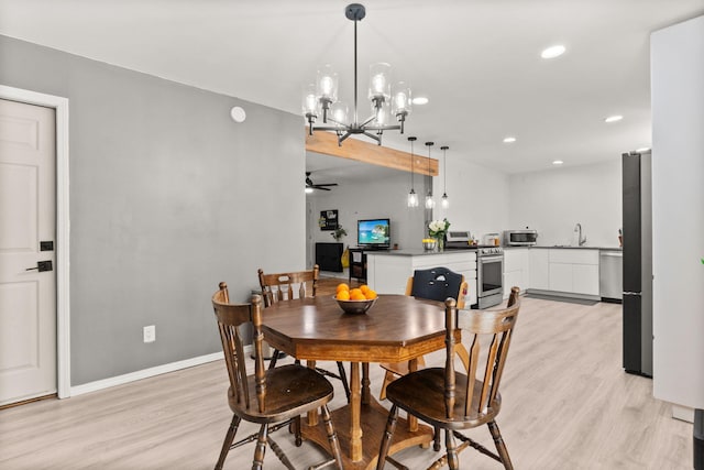 11608 Clifford Ave NE, Albuquerque, NM 87112 - dining space with light wood finished floors, ceiling fan, recessed lighting, and a chandelier