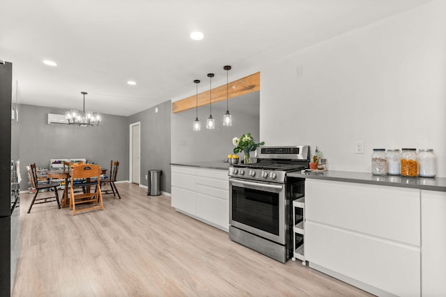 11608 Clifford Ave NE, Albuquerque, NM 87112 - kitchen featuring stainless steel gas range oven, white cabinets, light wood-style floors, recessed lighting, and a chandelier
