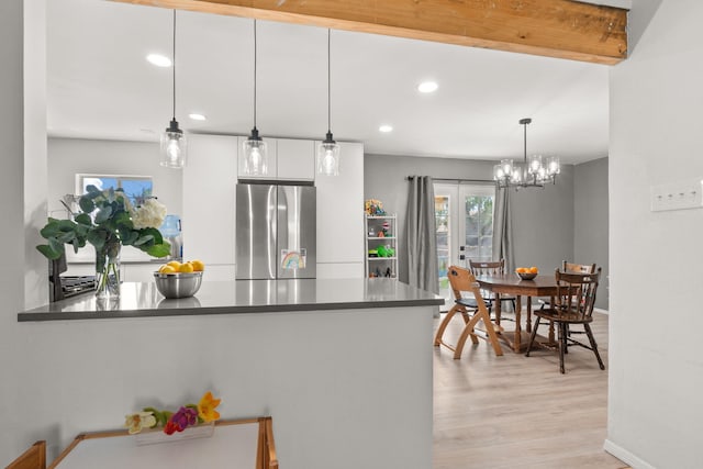 11608 Clifford Ave NE, Albuquerque, NM 87112 - kitchen with freestanding refrigerator, white cabinets, a peninsula, dark countertops, and recessed lighting