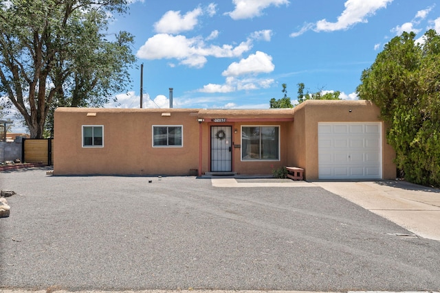 11608 Clifford Ave NE, Albuquerque, NM 87112 - view of front of house featuring an attached garage, stucco siding, and concrete driveway