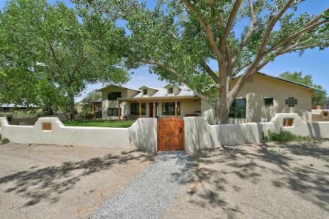 276 Trosello Ln, Corrales, NM 87048 - view of front facade featuring a gate, a fenced front yard, and stucco siding