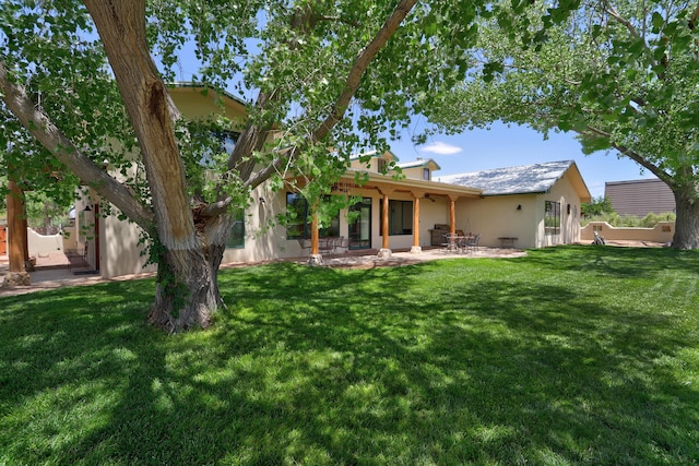 276 Trosello Ln, Corrales, NM 87048 - rear view of house with stucco siding, a patio area, and a yard