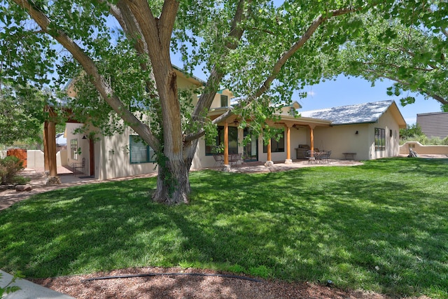 276 Trosello Ln, Corrales, NM 87048 - rear view of property featuring stucco siding, a patio area, and a lawn