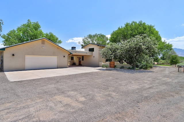 276 Trosello Ln, Corrales, NM 87048 - view of front of property with a garage, stucco siding, and concrete driveway
