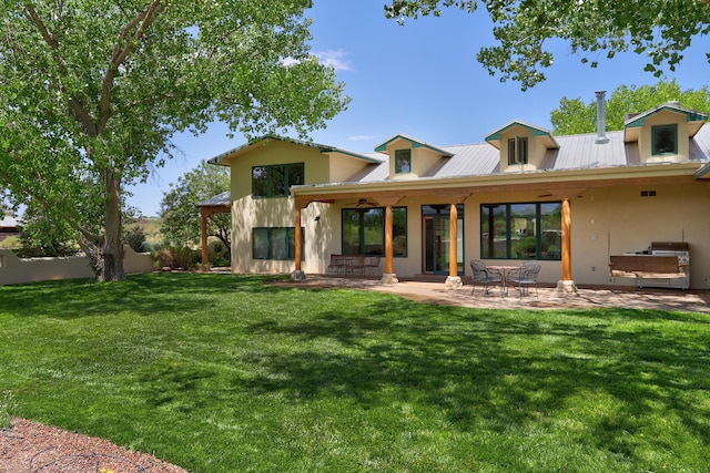 276 Trosello Ln, Corrales, NM 87048 - rear view of house with stucco siding, a yard, a metal roof, and a patio area