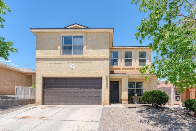 10405 Red Robin Rd SW, Albuquerque, NM 87121 - view of front of property with stucco siding, driveway, and an attached garage