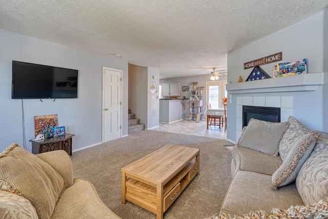 10405 Red Robin Rd SW, Albuquerque, NM 87121 - living room featuring carpet flooring, a ceiling fan, a textured ceiling, a fireplace, and stairs