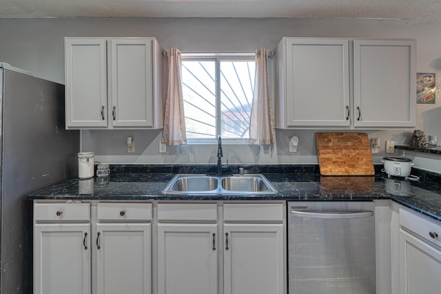 10405 Red Robin Rd SW, Albuquerque, NM 87121 - kitchen with dishwasher, white cabinetry, freestanding refrigerator, and dark stone countertops