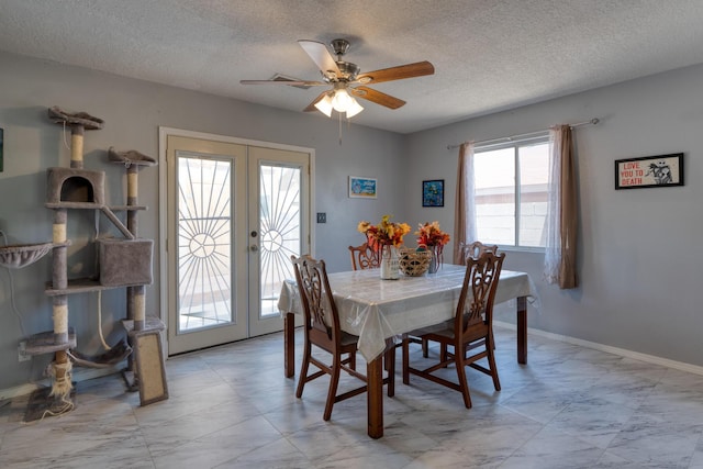 10405 Red Robin Rd SW, Albuquerque, NM 87121 - dining room featuring french doors, a ceiling fan, a textured ceiling, and light marble finish floors