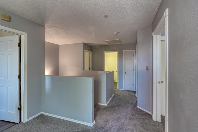 10405 Red Robin Rd SW, Albuquerque, NM 87121 - corridor featuring an upstairs landing, dark colored carpet, a textured ceiling, and attic access