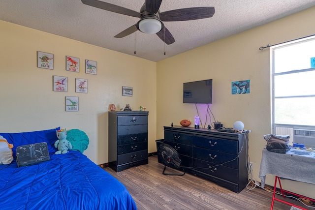 10405 Red Robin Rd SW, Albuquerque, NM 87121 - bedroom featuring wood finished floors, a textured ceiling, and ceiling fan