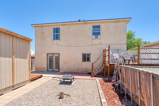 10405 Red Robin Rd SW, Albuquerque, NM 87121 - rear view of house with stucco siding, a fenced backyard, a patio, and an outdoor fire pit