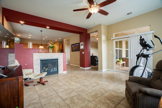3726 Linda Vista Ave NE, Rio Rancho, NM 87124 - living room with ceiling fan, light tile patterned floors, a tile fireplace, and recessed lighting