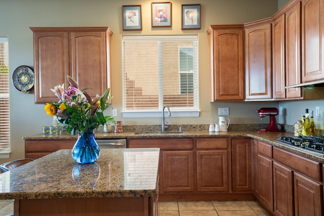 3726 Linda Vista Ave NE, Rio Rancho, NM 87124 - kitchen with gas cooktop, stone countertops, a center island, and light tile patterned flooring