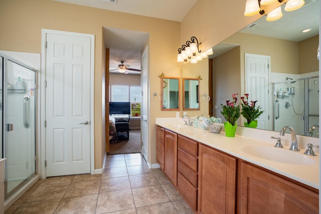 3726 Linda Vista Ave NE, Rio Rancho, NM 87124 - ensuite bathroom featuring double vanity, a stall shower, a ceiling fan, and tile patterned flooring