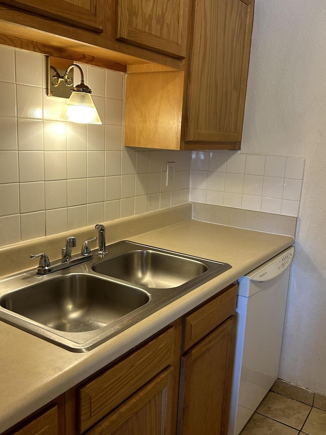 3847 Montgomery Blvd NE Unit 923, Albuquerque, NM 87109 - kitchen with dishwasher, decorative backsplash, light countertops, and brown cabinetry