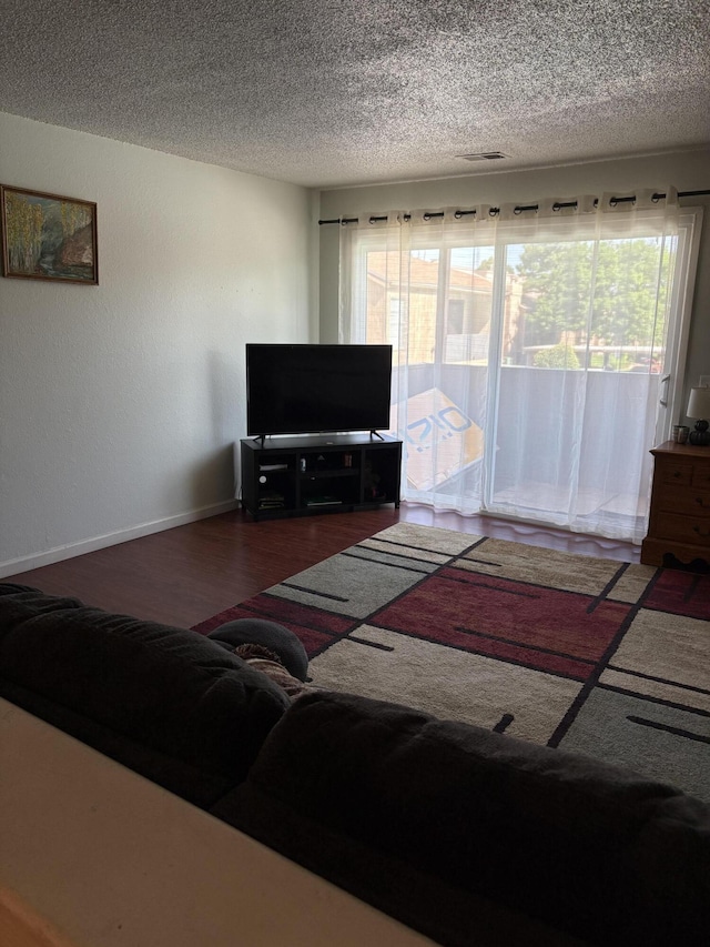3847 Montgomery Blvd NE Unit 923, Albuquerque, NM 87109 - living area with wood finished floors and a textured ceiling