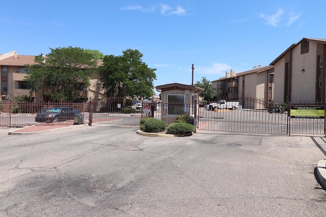 3847 Montgomery Blvd NE Unit 923, Albuquerque, NM 87109 - view of asphalt street featuring a gate, a gated entry, and curbs