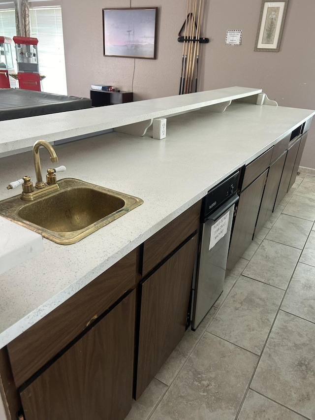 3847 Montgomery Blvd NE Unit 923, Albuquerque, NM 87109 - kitchen with dark brown cabinets and light tile patterned floors