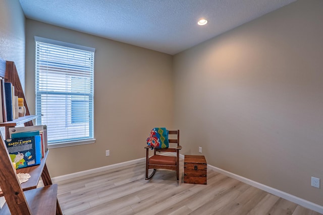 2952 Kings Canyon Loop NE, Rio Rancho, NM 87144 - sitting room with light wood-style floors, healthy amount of natural light, a textured ceiling, and recessed lighting