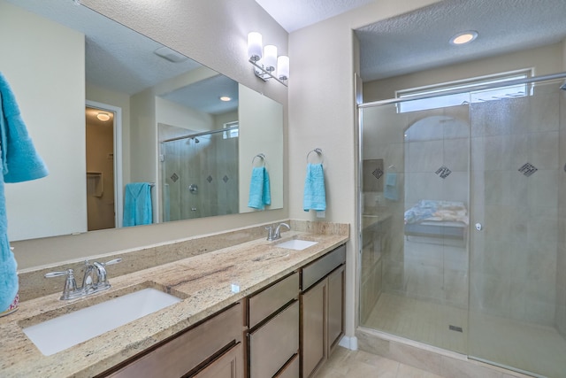 2952 Kings Canyon Loop NE, Rio Rancho, NM 87144 - bathroom featuring a stall shower and double vanity