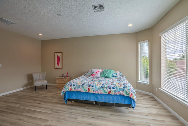2952 Kings Canyon Loop NE, Rio Rancho, NM 87144 - bedroom featuring wood finished floors, multiple windows, a textured ceiling, and recessed lighting